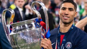 Achraf Hakimi poses with the Champions League trophy