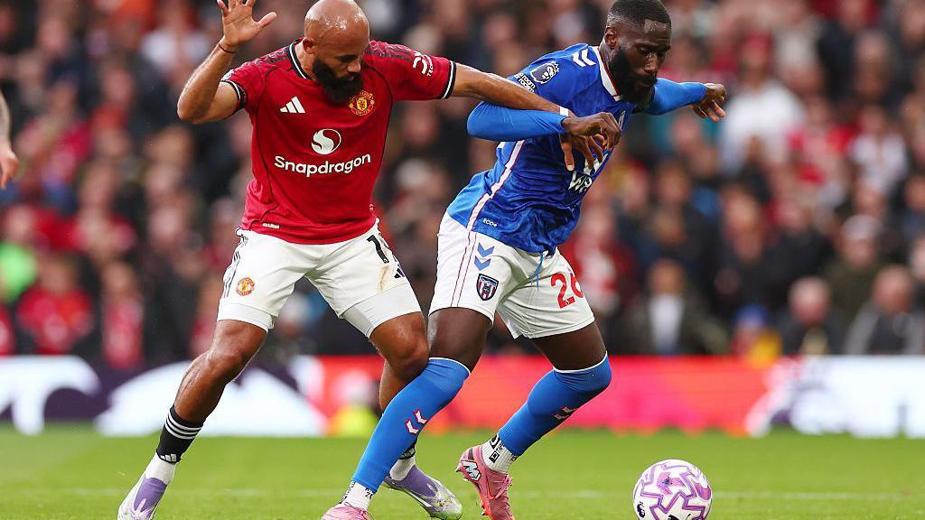 Manchester United's Bryan Mbeumo and Sunderland's Arthur Masuaku tussle for the ball