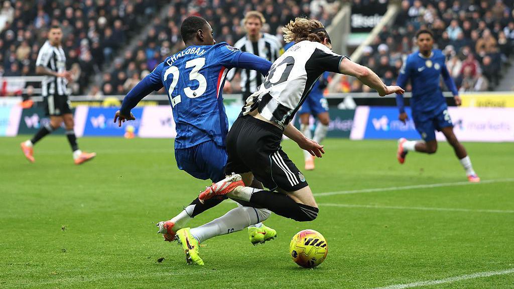 Newcastle forward Anthony Gordon is challenged inside the box by Chelsea defender Trevoh Chalobah