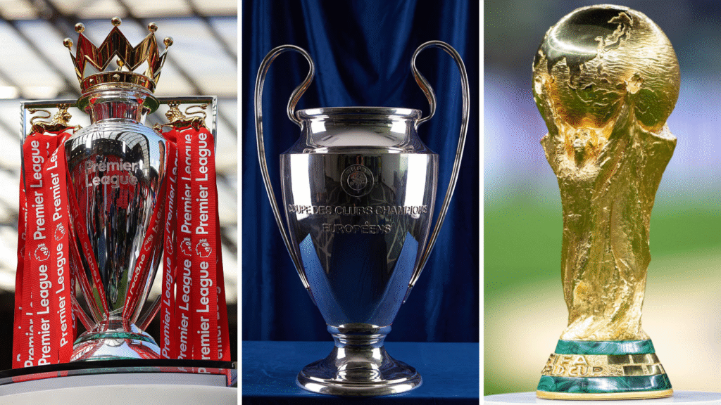 Premier League trophy (left), Champions League trophy (centre), World Cup trophy (right)