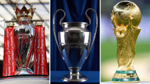 Premier League trophy (left), Champions League trophy (centre), World Cup trophy (right)