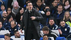 Unai Emery pointing and shouting while in the dugout in front of Aston Villa's bench at Stamford Bridge