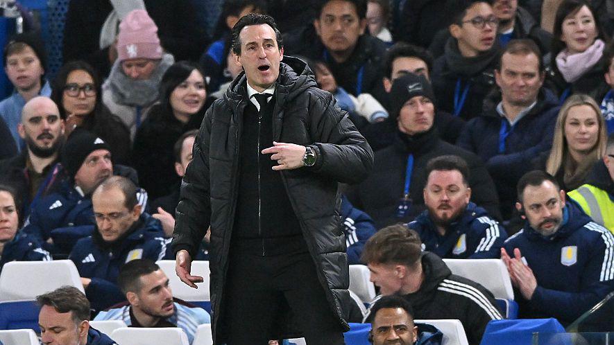 Unai Emery pointing and shouting while in the dugout in front of Aston Villa's bench at Stamford Bridge