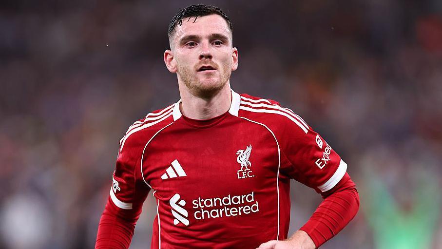 Andy Robertson wearing a red Liverpool match shirt