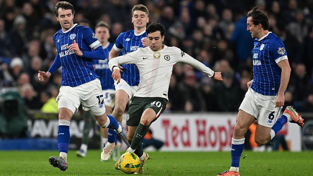 Chelsea's Facundo Buonanotte controls the ball while under pressure from Cardiff City's Calum Chambers during the Carabao Cup quarter-final