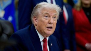 US President Donald Trump sits at his desk in the Oval Office