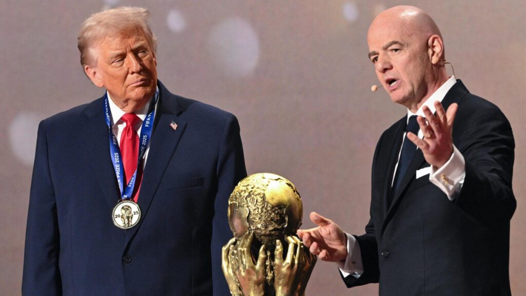 US President Donald Trump (left) and Fifa president Gianni Infantino (right) either side of the World Cup trophy at the 2026 tournament draw