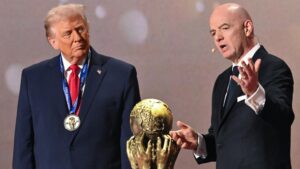US President Donald Trump (left) and Fifa president Gianni Infantino (right) either side of the World Cup trophy at the 2026 tournament draw